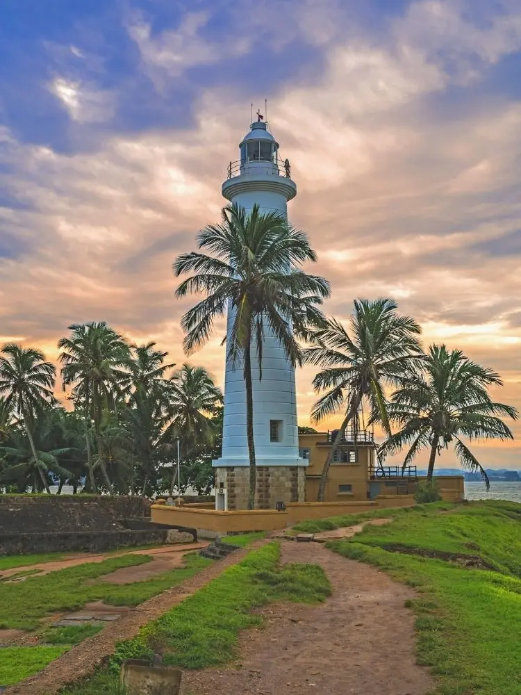 galle fort day tour Galle Fort lighthouse at sunset with tourists on ramparts